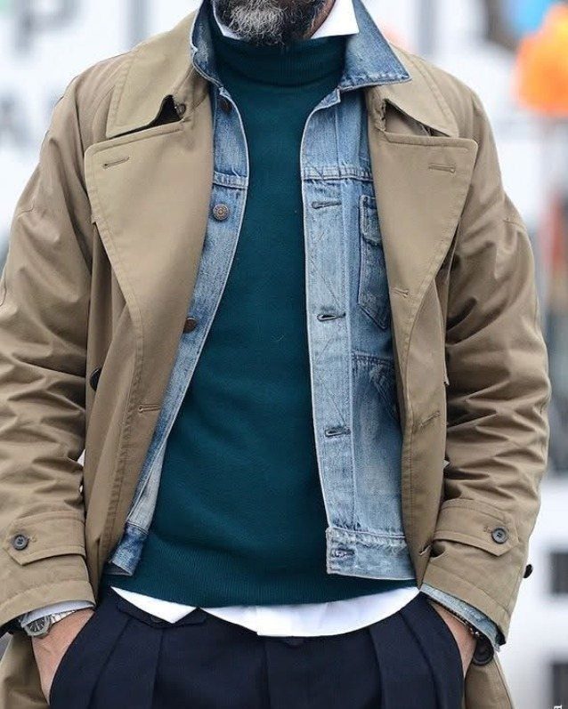 Beige trench coat layered over a denim jacket and teal turtleneck sweater.