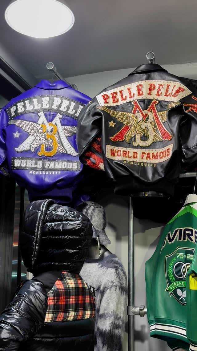 Two Pelle Pelle leather jackets with ornate gold and silver embroidery on the back.