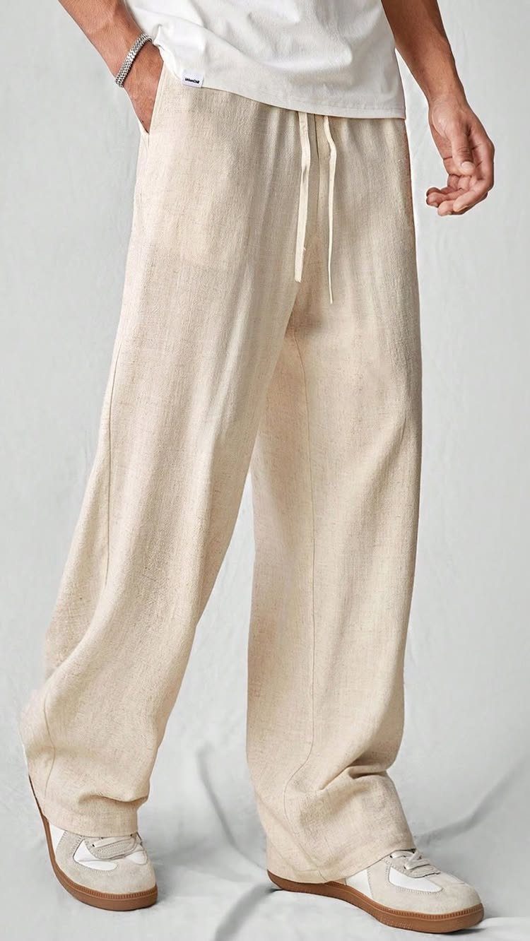 Cream linen wide-leg trousers and white t-shirt worn by a person.