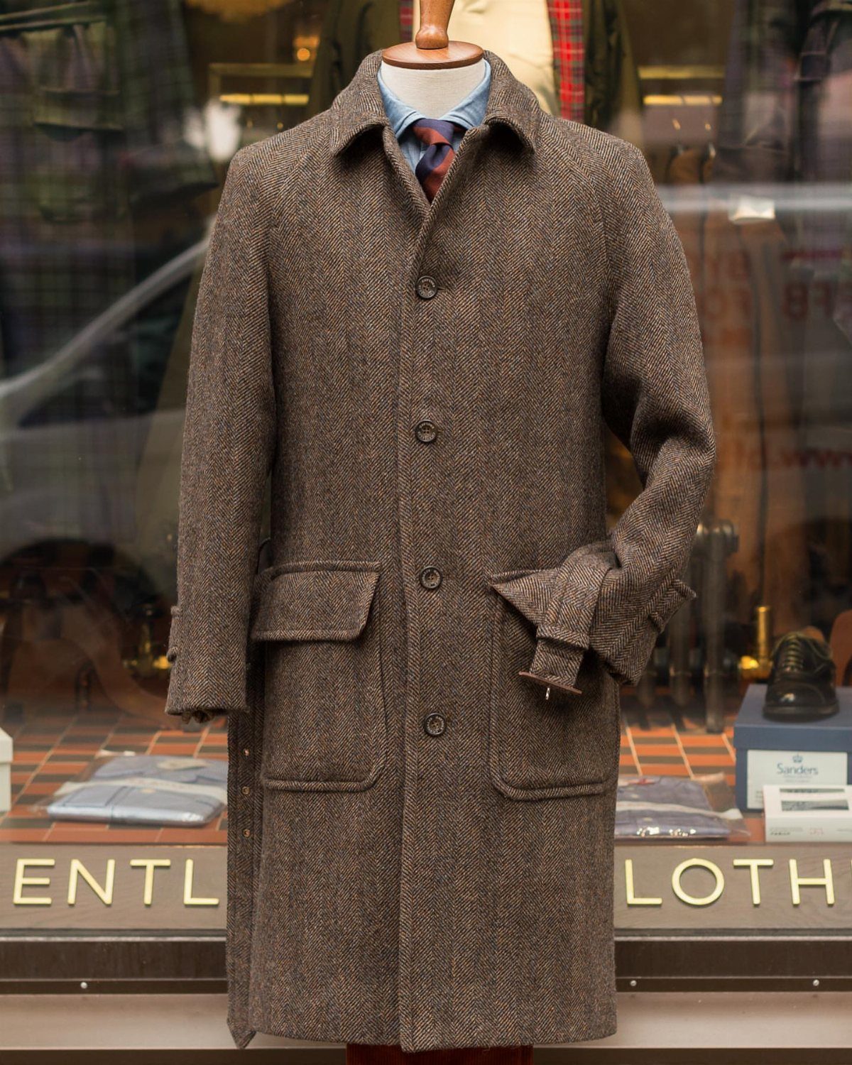 Brown textured wool overcoat on a mannequin in a store window display