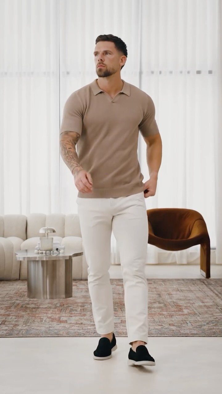 Man wearing a tan polo shirt and white slim-fit chinos in a bright room.