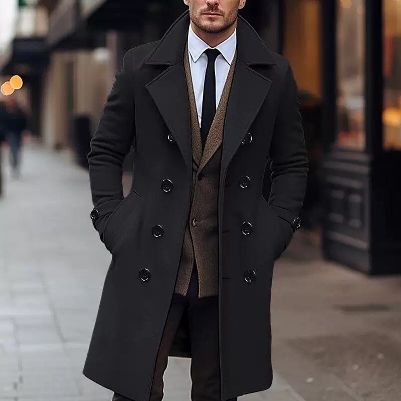 Man in black wool overcoat and brown vest on a city street